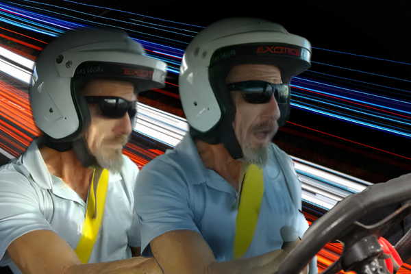 Two older men wearing white helmets and sunglasses drive an exotic car at high speed, with bold blue and red light trails in the background highlighting motion and adrenaline.