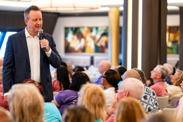 Speaker addressing travel advisors during KHM Travel Group Crystal Conference session