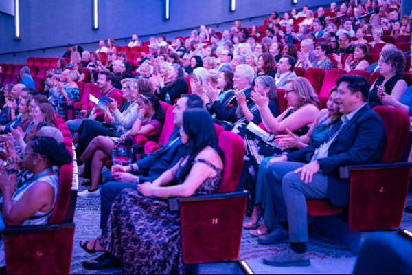 Audience applauding during conference session at KHM Travel Group Crystal Conference