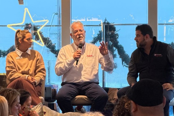 Travel industry leaders speaking on a panel at an OutsideAgents.com advisor event