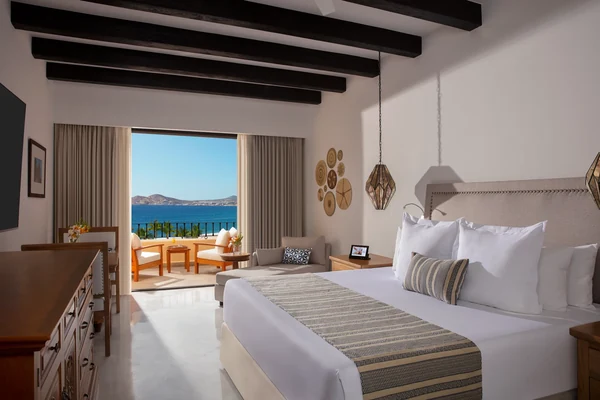 Ocean view junior suite at Zoetry Casa del Mar Los Cabos with king bed, wooden beam ceiling, and private balcony