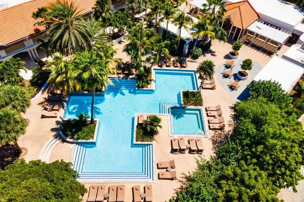 Aerial view of the pool and surrounding palm trees at Zoetry Curacao Resort and Spa