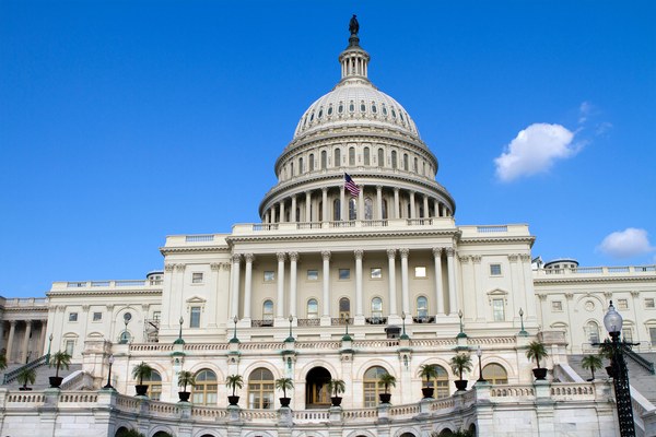 The United States Capitol building in Washington, D.C. with its iconic dome and American flag, central to the American Stories Travel multi-destination itineraries