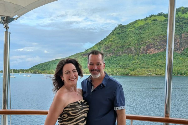 Brenda and Stephen Steve Daisey, Cruise Planners franchise owners since 2008, posing aboard a Silversea cruise ship deck in Tahiti