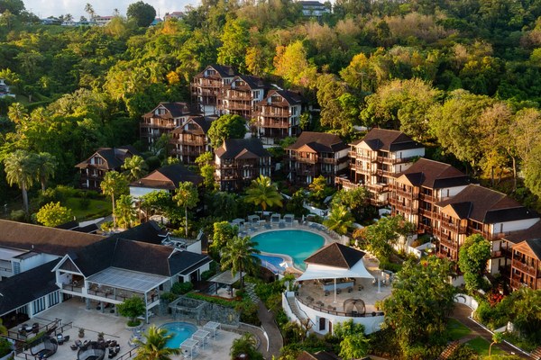 Hillside aerial view of Zoëtry Marigot Bay with terracotta-roofed villas tucked into the lush green St. Lucian rainforest