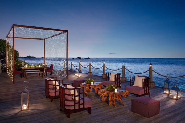 Twilight banquet and lounge setup on the pier with twinkling string lights and lanterns at Zoëtry Montego Bay, Jamaica