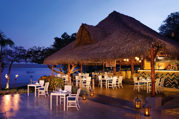 Seaside Grill open-air dining at dusk at Secrets Papagayo