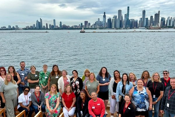 Dugan’s Travels advisors together at the Chicago Bootcamp with the city skyline behind them